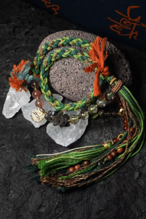 Taurus Earth-Weaved Calm Bracelet — Green & Soft Brown × Woven Stability Colors speak to the grounded heart of Taurus: this bracelet weaves invisible emotions of growth, abundance, and steady calm into tangible color—with lush green and warm soft brown as the foundation. Inspired by Earth’s quiet strength, every strand of natural silk and each crystal is chosen to mirror Taurus’ need for security, progress, and emotional rootedness. It’s not just jewelry; it’s a wearable reminder of your ability to grow slowly, thrive steadily, and hold space for calm. ✨ Emotional Weaving (Color × Feeling)This bracelet uses earthy hues to amplify: Green: The energy of growth — nurtures ambition, attracts abundance, and fosters patience as things unfold naturally. Soft Brown: The anchor of stability — grounds scattered thoughts, builds emotional security, and reminds you of your unshakable foundation. Together, green and soft brown create an emotional synergy: growth without rush, abundance with gratitude, and calm that lasts through change. 🪨 Crystal Color & EnergyEach crystal echoes the bracelet’s earthy color story and enhances Taurus-aligned emotions:• Green Phantom Quartz (Primary Stone) — Lush green tones mirror the cord’s growth energy; attracts wealth, supports personal development, and turns dreams into tangible progress.• Additional Green Phantom Quartz — Deepens the green color palette; amplifies abundance energy and strengthens connection to Earth’s grounding force.• Rose Quartz — Soft pink hues complement green & brown; adds gentle warmth, fostering self-compassion amid growth.• Smoky Quartz — Muted brown tones align with the soft brown cord; grounds excess energy, reduces stress, and enhances emotional stability. 🧵 Color-Centric CraftHandwoven with 100% natural silk cord — smooth, earthy, and designed to let nature’s hues shine: Rich, forest-inspired green cord: The star of the design, chosen for its association with growth, prosperity, and Taurus’ love of nature. Warm soft brown thread accents: Adds depth and calm, balancing green’s vitality with a sense of rooted security. Intention-driven knots: Each weave ties color to emotion, so wearing it becomes a daily practice of "activating" steady growth and calm. 🌿 Wear Your EmotionThis bracelet is a color-coded emotional tool for Taurus’ grounded spirit: Wear it when you need patience (e.g., long-term projects, personal growth journeys). Let green and brown remind you to trust the process—growth takes time, and stability is your superpower. Pair it with earthy tones or neutrals to amplify its natural, calm energy. 🎁 Gift Meaning"May this green nurture your growth, and this brown steady your path — thrive in calm, grow in abundance."Perfect for Taurus, nature lovers, anyone seeking stability, or those wanting to align with Earth’s quiet strength.