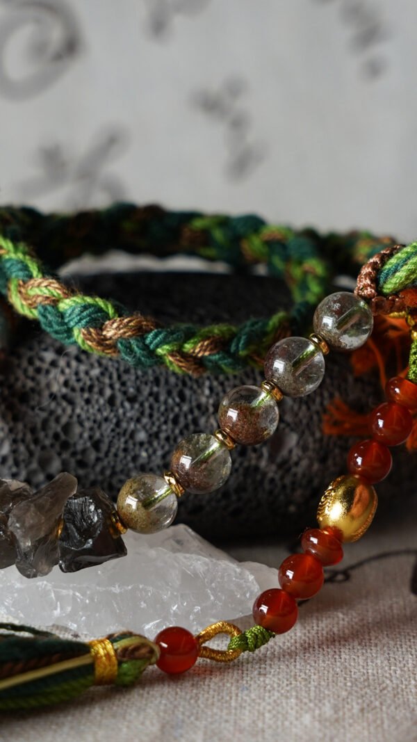 Taurus Earth-Weaved Calm Bracelet — Green & Soft Brown × Woven Stability Colors speak to the grounded heart of Taurus: this bracelet weaves invisible emotions of growth, abundance, and steady calm into tangible color—with lush green and warm soft brown as the foundation. Inspired by Earth’s quiet strength, every strand of natural silk and each crystal is chosen to mirror Taurus’ need for security, progress, and emotional rootedness. It’s not just jewelry; it’s a wearable reminder of your ability to grow slowly, thrive steadily, and hold space for calm. ✨ Emotional Weaving (Color × Feeling)This bracelet uses earthy hues to amplify: Green: The energy of growth — nurtures ambition, attracts abundance, and fosters patience as things unfold naturally. Soft Brown: The anchor of stability — grounds scattered thoughts, builds emotional security, and reminds you of your unshakable foundation. Together, green and soft brown create an emotional synergy: growth without rush, abundance with gratitude, and calm that lasts through change. 🪨 Crystal Color & EnergyEach crystal echoes the bracelet’s earthy color story and enhances Taurus-aligned emotions:• Green Phantom Quartz (Primary Stone) — Lush green tones mirror the cord’s growth energy; attracts wealth, supports personal development, and turns dreams into tangible progress.• Additional Green Phantom Quartz — Deepens the green color palette; amplifies abundance energy and strengthens connection to Earth’s grounding force.• Rose Quartz — Soft pink hues complement green & brown; adds gentle warmth, fostering self-compassion amid growth.• Smoky Quartz — Muted brown tones align with the soft brown cord; grounds excess energy, reduces stress, and enhances emotional stability. 🧵 Color-Centric CraftHandwoven with 100% natural silk cord — smooth, earthy, and designed to let nature’s hues shine: Rich, forest-inspired green cord: The star of the design, chosen for its association with growth, prosperity, and Taurus’ love of nature. Warm soft brown thread accents: Adds depth and calm, balancing green’s vitality with a sense of rooted security. Intention-driven knots: Each weave ties color to emotion, so wearing it becomes a daily practice of "activating" steady growth and calm. 🌿 Wear Your EmotionThis bracelet is a color-coded emotional tool for Taurus’ grounded spirit: Wear it when you need patience (e.g., long-term projects, personal growth journeys). Let green and brown remind you to trust the process—growth takes time, and stability is your superpower. Pair it with earthy tones or neutrals to amplify its natural, calm energy. 🎁 Gift Meaning"May this green nurture your growth, and this brown steady your path — thrive in calm, grow in abundance."Perfect for Taurus, nature lovers, anyone seeking stability, or those wanting to align with Earth’s quiet strength.