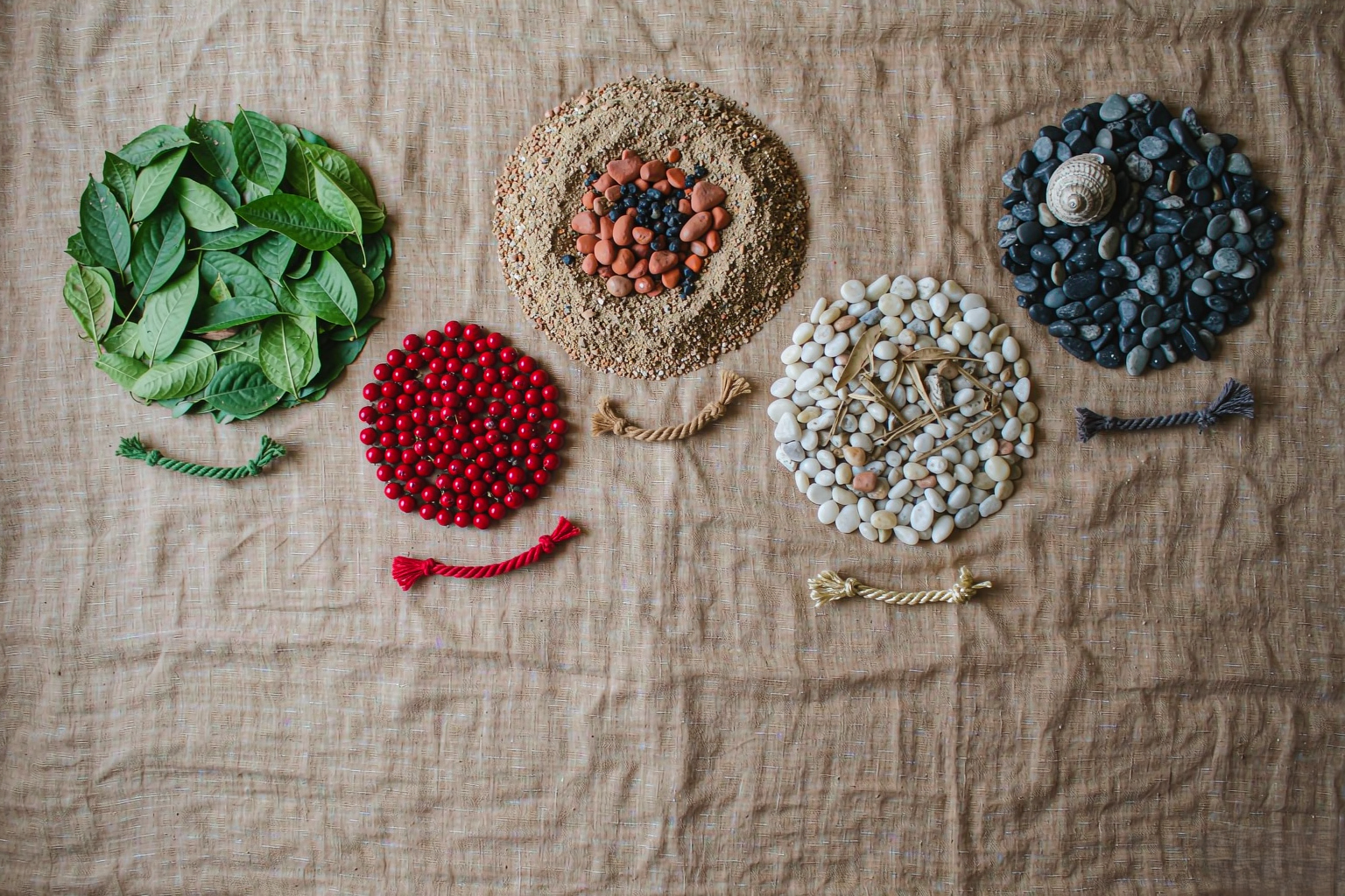 five handwoven jewelry palettes in a circle of natural colors on linen — Five Elements Jewelry by TibetanTwist